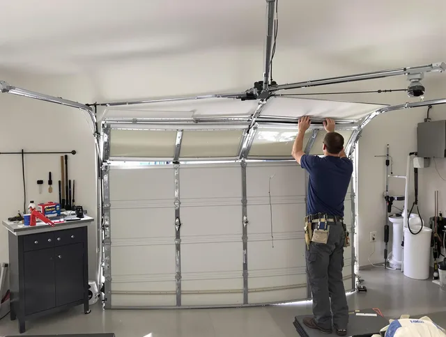 South Windsor Garage Door Repair specialist performing precise section replacement on South Windsor garage door